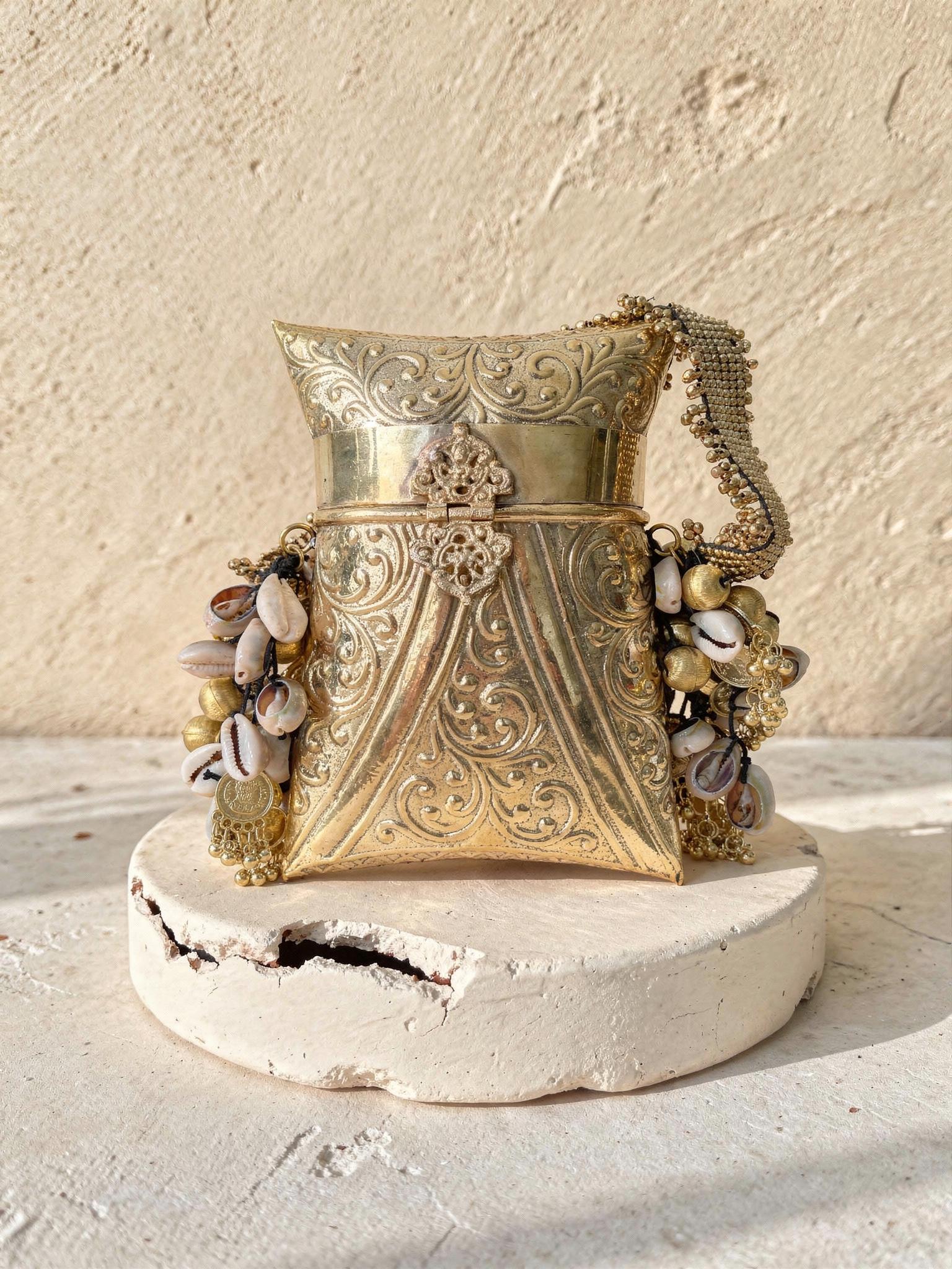 Rivaaz Engraved Brass Potli Bag with Cowrie Shells - Outbox House